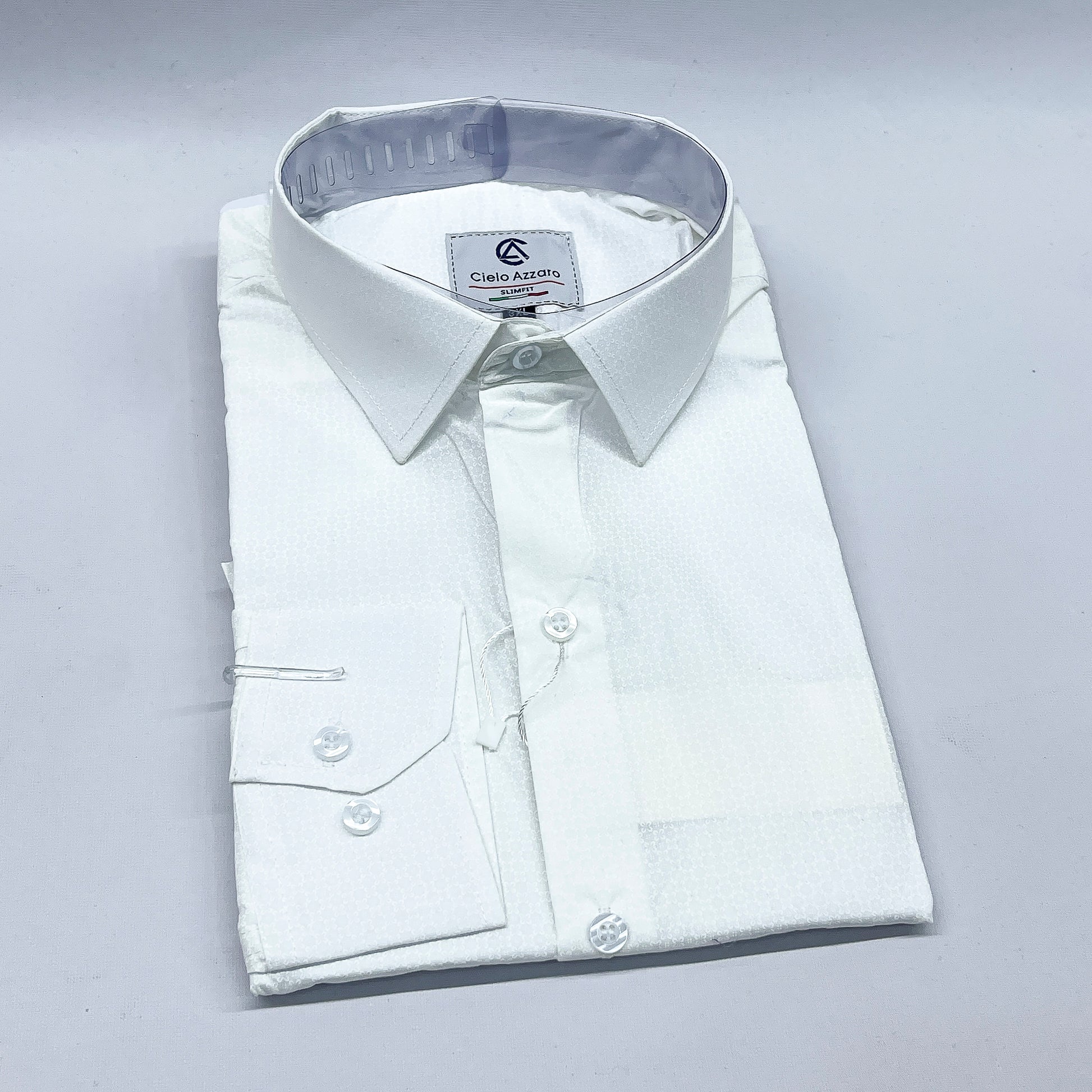 Folded white dress shirt with a visible brand label on a light gray background